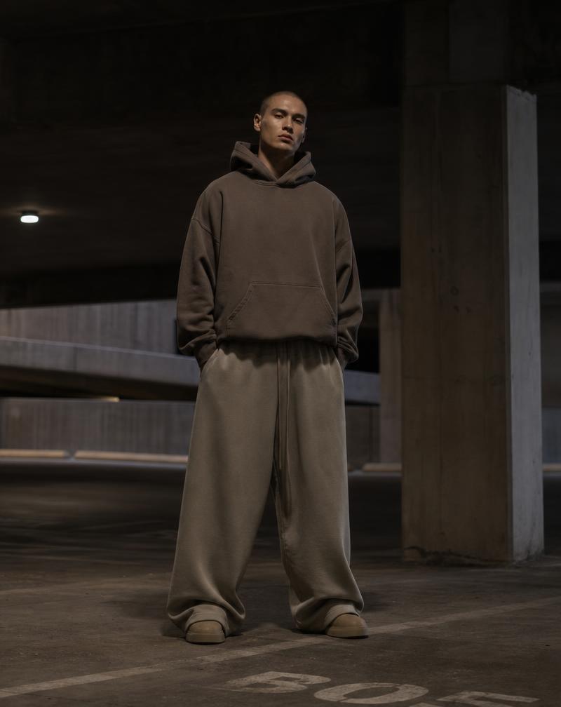 Wide leg joggers on a model in a concrete parking garage